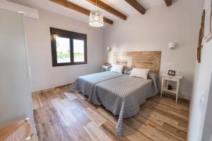 代米耶尔Casa Rural Las Caleras的一间卧室配有一张床,铺有木地板