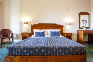 潘泰莱里亚Suvaki Resort的一间卧室配有一张带蓝色棉被的床