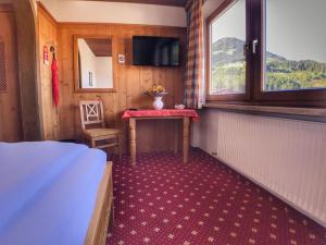 蒂罗尔-基希贝格贝赫维尔特酒店的小房间设有桌子和窗户
