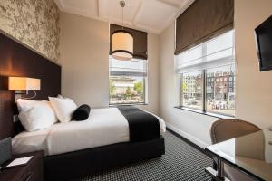 阿姆斯特丹诺丁山精品酒店的酒店客房设有一张床和两个窗户。
