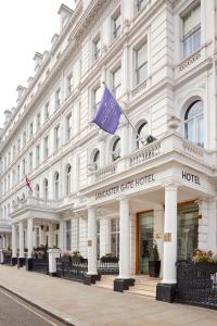 伦敦兰切斯特大门酒店的一座白色的大建筑,上面有紫色的旗帜