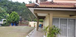 万挠Tun Perak Homestay的享有带车库的房屋侧面景致