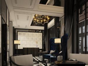 河内Hanoi Paradise Center Hotel & Spa的客厅配有椅子和吊灯。