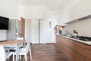 米兰Isola View Renovated Apartment的厨房以及带桌椅的用餐室。