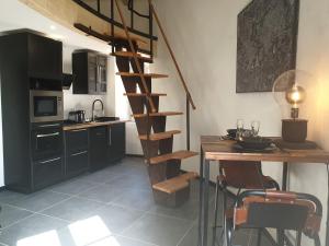 多勒Tour de Lacuzon的厨房设有木制螺旋楼梯,旁边是桌子