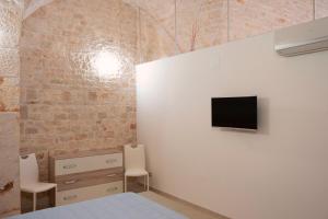 图里Pietranuova的一间卧室配有一张床,墙上配有电视