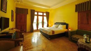 普兰巴南卢玛德萨旅馆的一间卧室配有一张床、一台电视和一张沙发