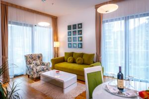 布德瓦Luxury Budva Center Apartments的客厅配有绿色沙发和桌子