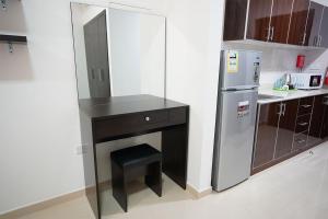 拉斯阿尔卡麦Aurak Guest House的一间带柜台和冰箱的小厨房