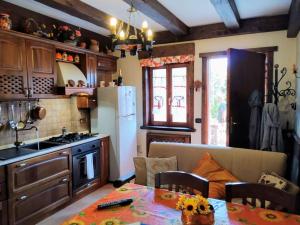 桑格罗堡La Chiave del Gufo - Castel di Sangro的厨房配有桌子和白色冰箱。