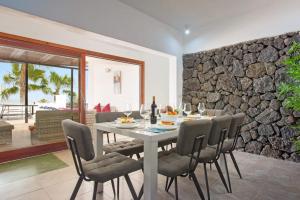 普拉亚布兰卡克利托别墅的一间设有桌椅和石墙的用餐室