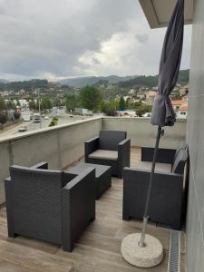 卡贝塞拉什德巴什图Basto Vila Hotel的屋顶上带椅子和遮阳伞的天井