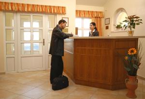 奥布道巴伐利亚酒店的站在女人面前的柜台上的男人