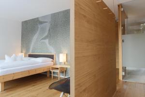 维皮泰诺斯坦德尔精品酒店的一间卧室设有一张床和玻璃墙