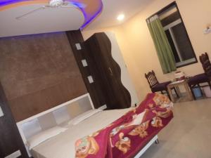 卜山Exotic Stay Near Shivaji Marg的一间卧室配有一张床铺,床上铺有红色毯子