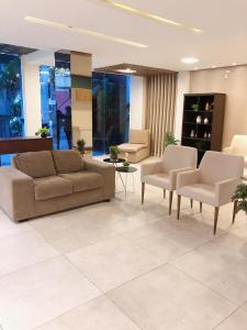 福塔莱萨Angra Praia Hotel的大楼内客厅配有沙发和椅子