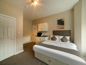 绍斯波特OYO Tequila and Dunlin Rooms Southport Central的一间卧室,卧室内配有一张大床