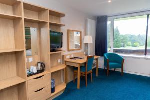 特尔福德Lilleshall House & Gardens and Lilleshall National Sports Centre的酒店客房配有书桌和电视。