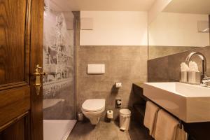 采尔马特丹妮拉酒店的浴室配有卫生间、盥洗盆和浴缸。