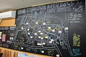 别府Beppu Kannawa Onsen HIROMIYA的墙上的黑板,上面有热点图