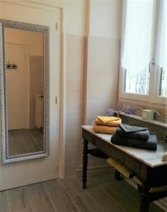 MorlaasLe Clos Sainte Foy的浴室设有镜子和一张带毛巾的桌子