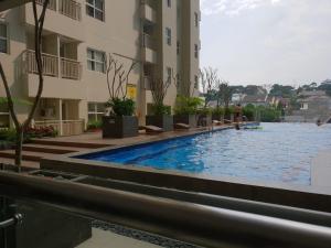 万隆威尔公寓 - 帕拉亚甘住宿的大楼前的游泳池