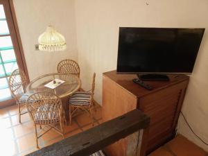 弗洛里亚诺波利斯Pousada da Lagoinha的客厅配有桌子和平面电视。