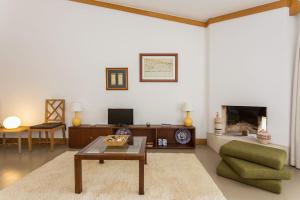 阿尔曼萨1Bed Apart Quinta do Lago的带沙发、桌子和壁炉的客厅