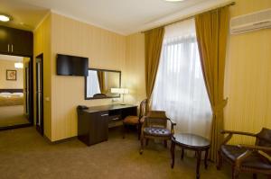 MylaCitadel Hotel的酒店客房设有书桌和窗户。