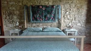 Monte Grimano TermeCasale Le Fontanelle的一间卧室配有床和2个床头柜