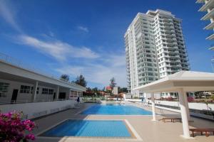 米里Bay Resort Condominium, 7, Beach-front Sea view, 6-8 PAX的一座高楼前的游泳池