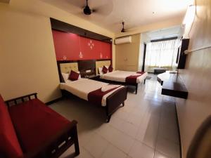 蓬蒂切里Ravi Krishna Inn的酒店客房,设有两张床和一张沙发