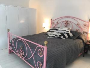 卡塔尼亚a casa del reuccio的粉红色的床和黑白枕头