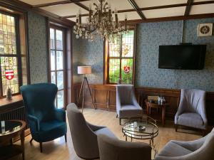 施内沃丁根兰德哈昊鹏酒店的客厅配有椅子和平面电视