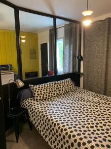 勒芒L'Atelier的一间卧室配有一张大床和一张 ⁇ 子毯子