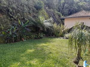 彼得罗波利斯Loft Aconchego da Serra的草地和树屋的院子