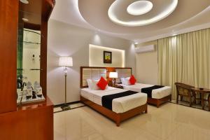 泰布克Dreams Houses furnished Suites的一间卧室配有两张带红色枕头的床
