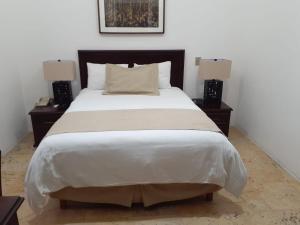 瓦哈卡市Hotel Casa las Mercedes的一间卧室配有一张带2个床头柜的大床