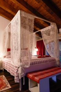 维琴察Country Home B&B Il Melo的一间卧室配有带窗帘的天蓬床