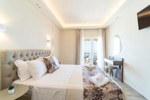 佩雷亚Luxury Plateia Rooms的一间卧室设有一张床,享有海景