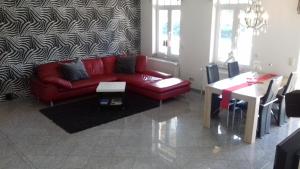 埃森鲁尔多米兹尔度假屋的客厅配有红色的沙发和桌子