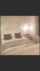 兰贝德泰莫尔酒店的卧室内的一张带两个枕头的白色床