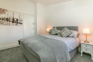 斯蒂夫尼奇Hillcrest Lodge的一间卧室,配有一张床和床头灯