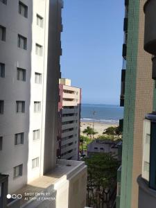 桑托斯Residencial Estanconfort Santos的阳台享有建筑和海滩的景致。