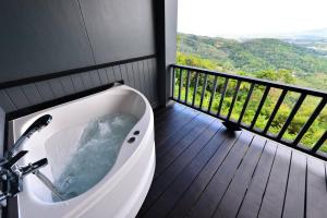查龙Phuket View Coffee and Resort的带阳台的客房内的浴缸
