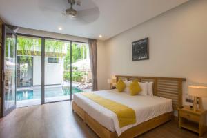 会安MaiChi Villa Hoi An的一间卧室设有一张床和一个游泳池