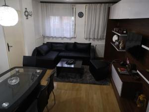 皮罗特Guest House Villa Krstic的客厅配有黑色沙发和桌子