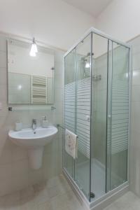 普蒂尼亚诺Casa Riccardi的一间带玻璃淋浴和水槽的浴室