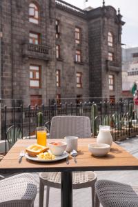 墨西哥城普林西帕尔酒店的一张木桌,上面有早餐食品和饮料