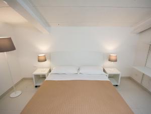 圣塞韦罗Palazzo di Fazio Suites的一间卧室配有一张大床和两张桌子